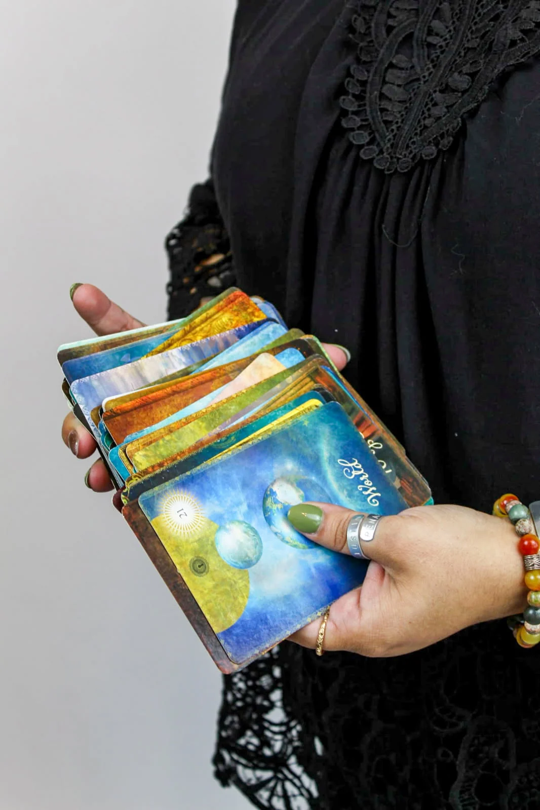 Renae holding her oracle cards for an intuitive reading