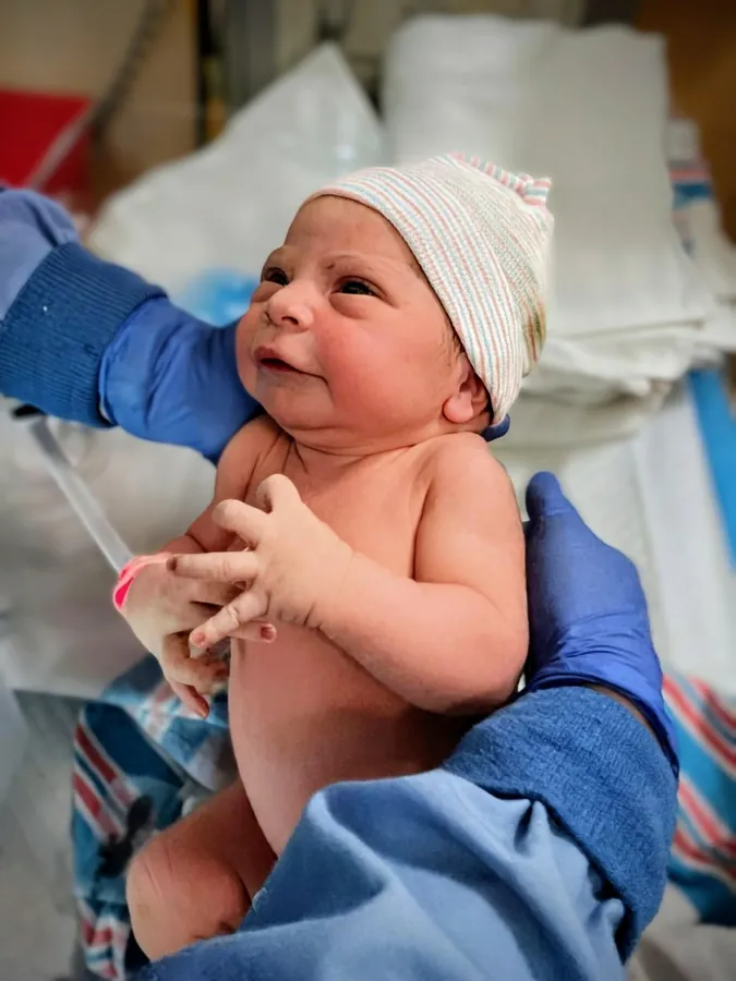 Fresh 48 newborn wrapped and held
