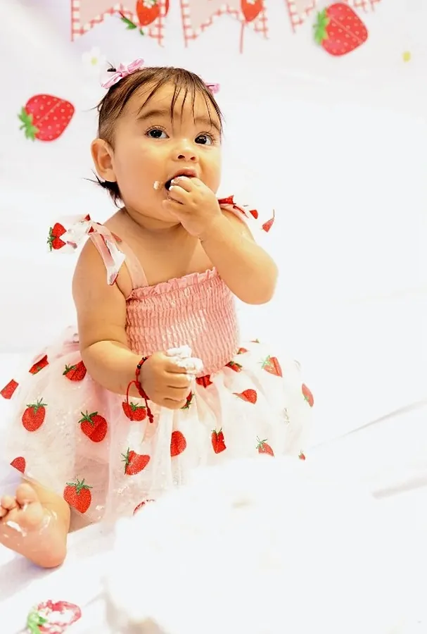 One year old in a strawberry tulle dress