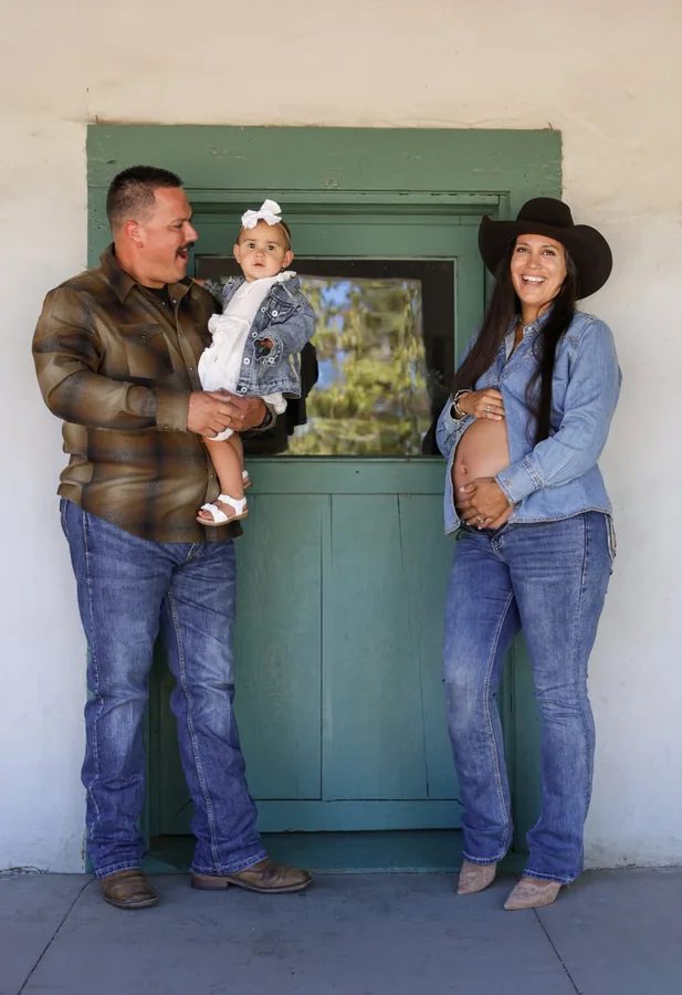 Family maternity session on a ranch porch by a green door