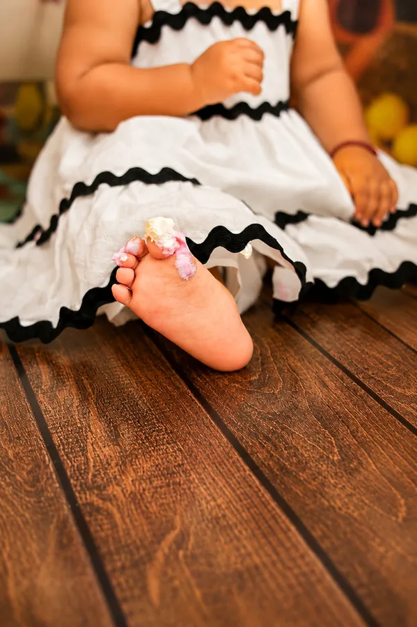 Frosting between her toes after the cake smash